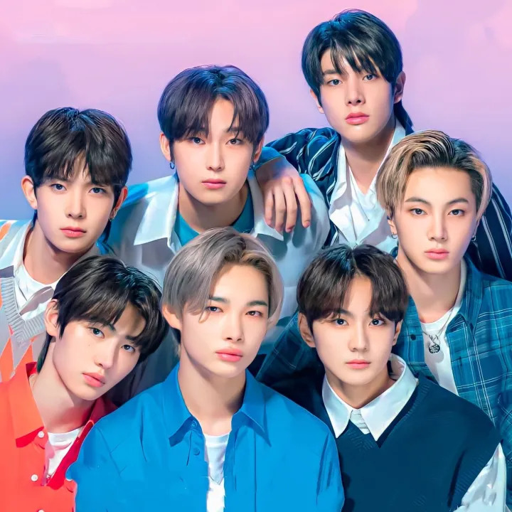 Seven young men in a studio group portrait with a pink and purple gradient background.