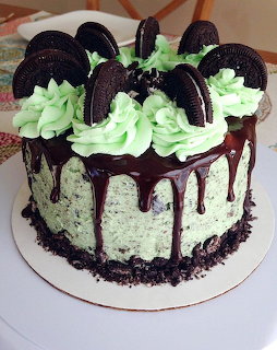 Mint chocolate cake with Oreo cookies and dark chocolate drip on white plate