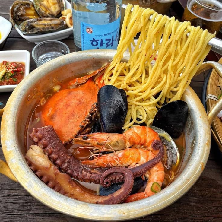Bowl of Korean seafood noodle soup with crab, shrimp, mussels, octopus, and noodles