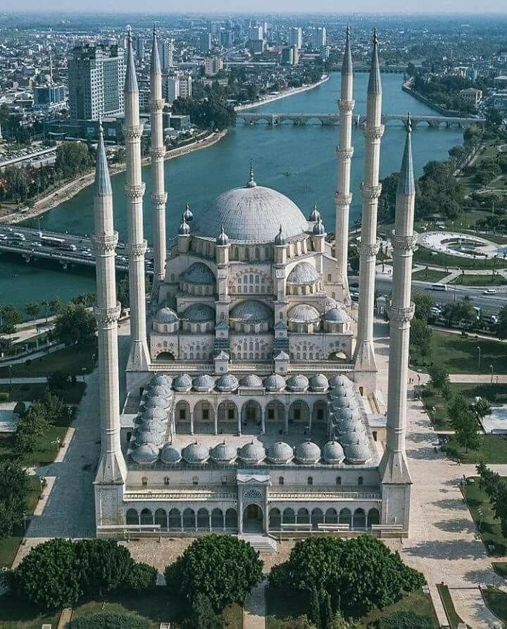 Aerial view of Sabancı Central Mosque in Adana, Turkey, with six minarets and a large dome beside a river