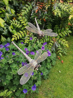 Metal dragonfly garden ornaments on display outdoors