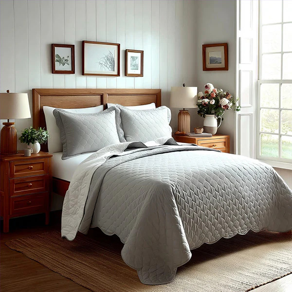 Peaceful bedroom with wooden furniture, gray bedding, white pillows, nightstands, wall art, and bright window