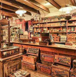 Interior of vintage general store with wooden shelves filled with antique boxes and products under hanging lamps