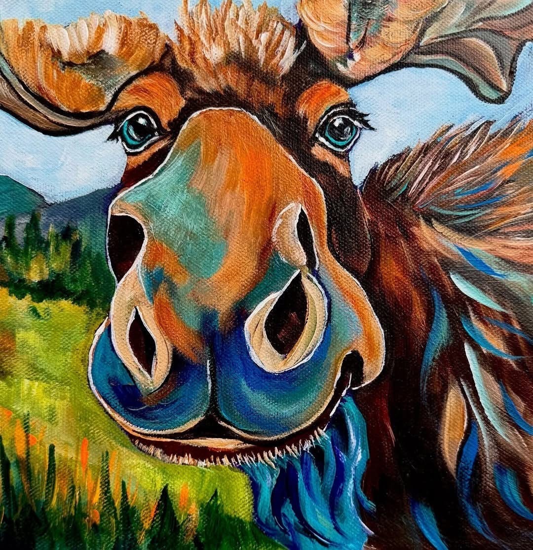 Colorful painted moose with large antlers and blue snout looking directly at viewer