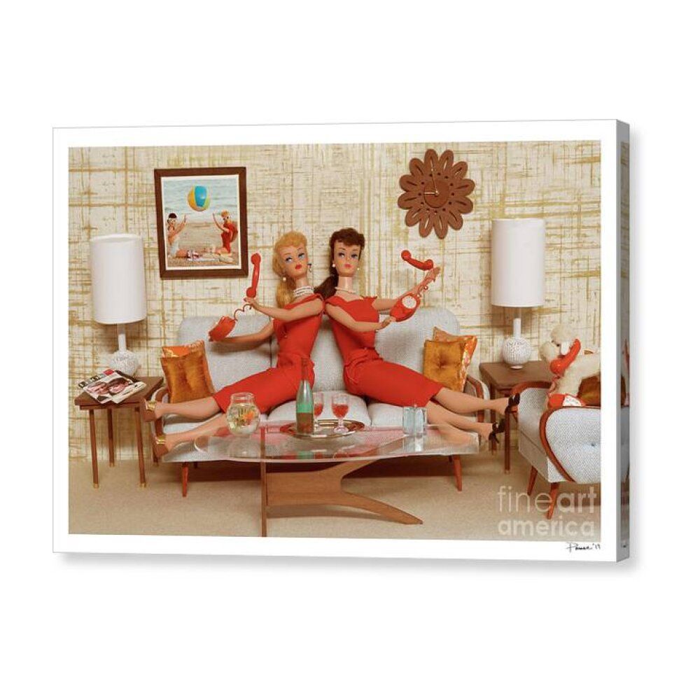 Two fashion dolls in red outfits posing on a sofa in a retro living room