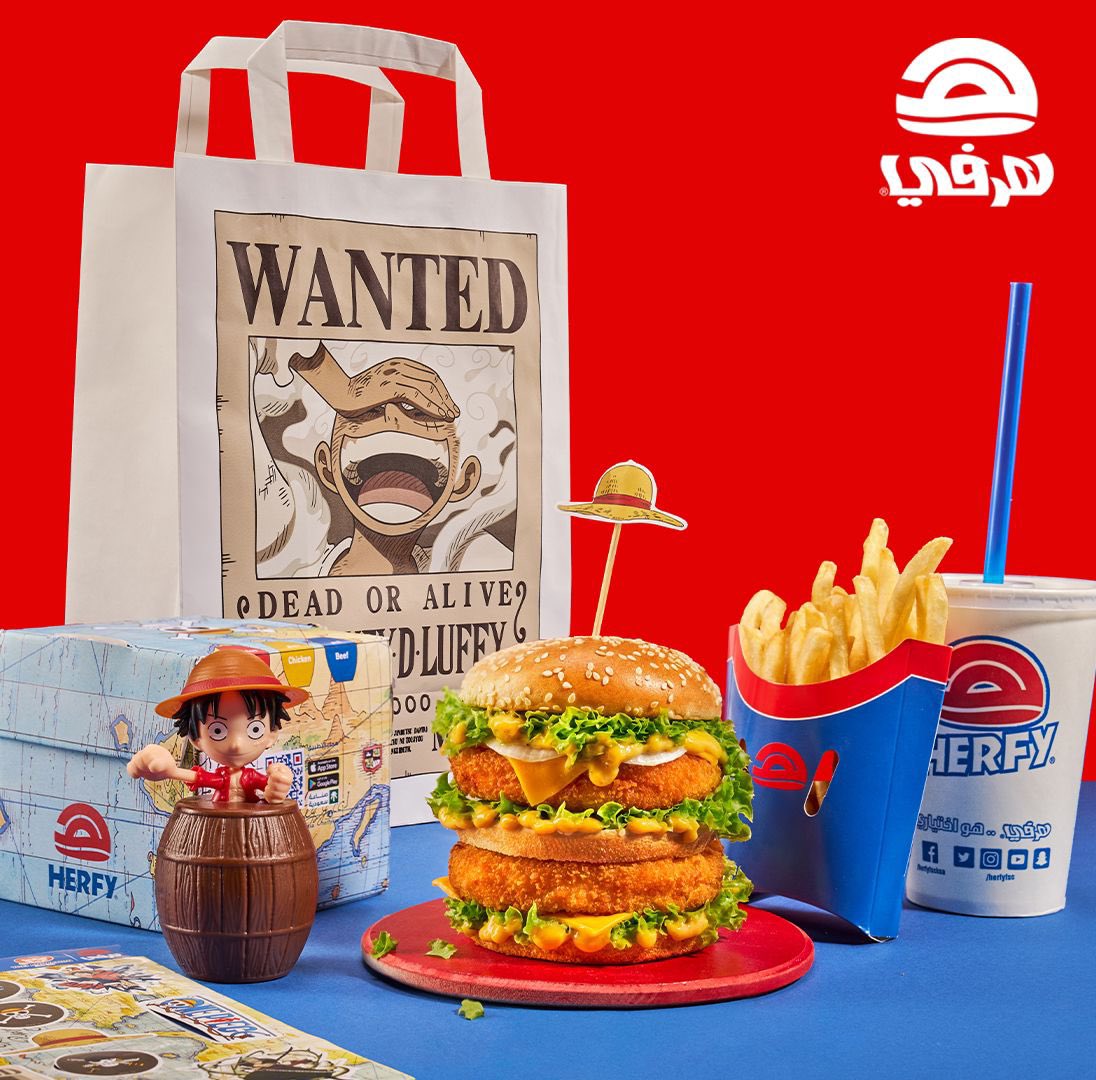 One Piece anime collaboration meal with Luffy figure, burger, fries and Herfy branded items on blue and red background