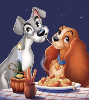 Animated dogs Lady and Tramp sharing spaghetti dinner scene from Disney movie