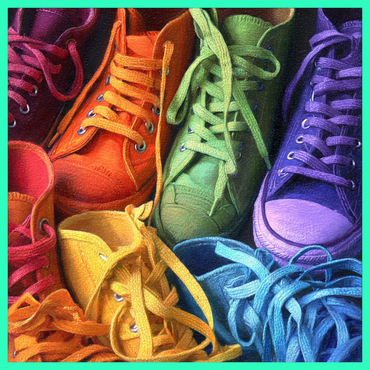 Rainbow arrangement of colorful canvas sneakers from red through orange, yellow, green, blue to purple