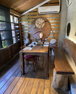 Rustic wooden dining room with table, chairs, bench, and wall decor