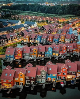 Aerial view of colorful waterfront houses in Groningen Netherlands at twilight