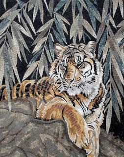 Stone mosaic artwork of a tiger resting among bamboo leaves