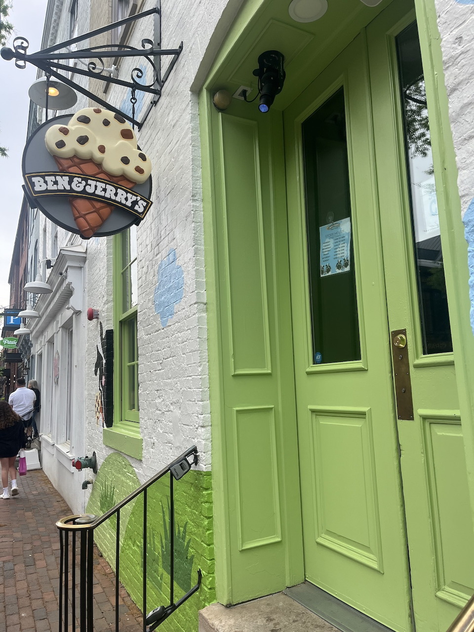Ben & Jerry's ice cream shop exterior with lime green door and hanging cone sign