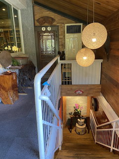 Wooden staircase in home interior with pendant lamps and wood ceiling
