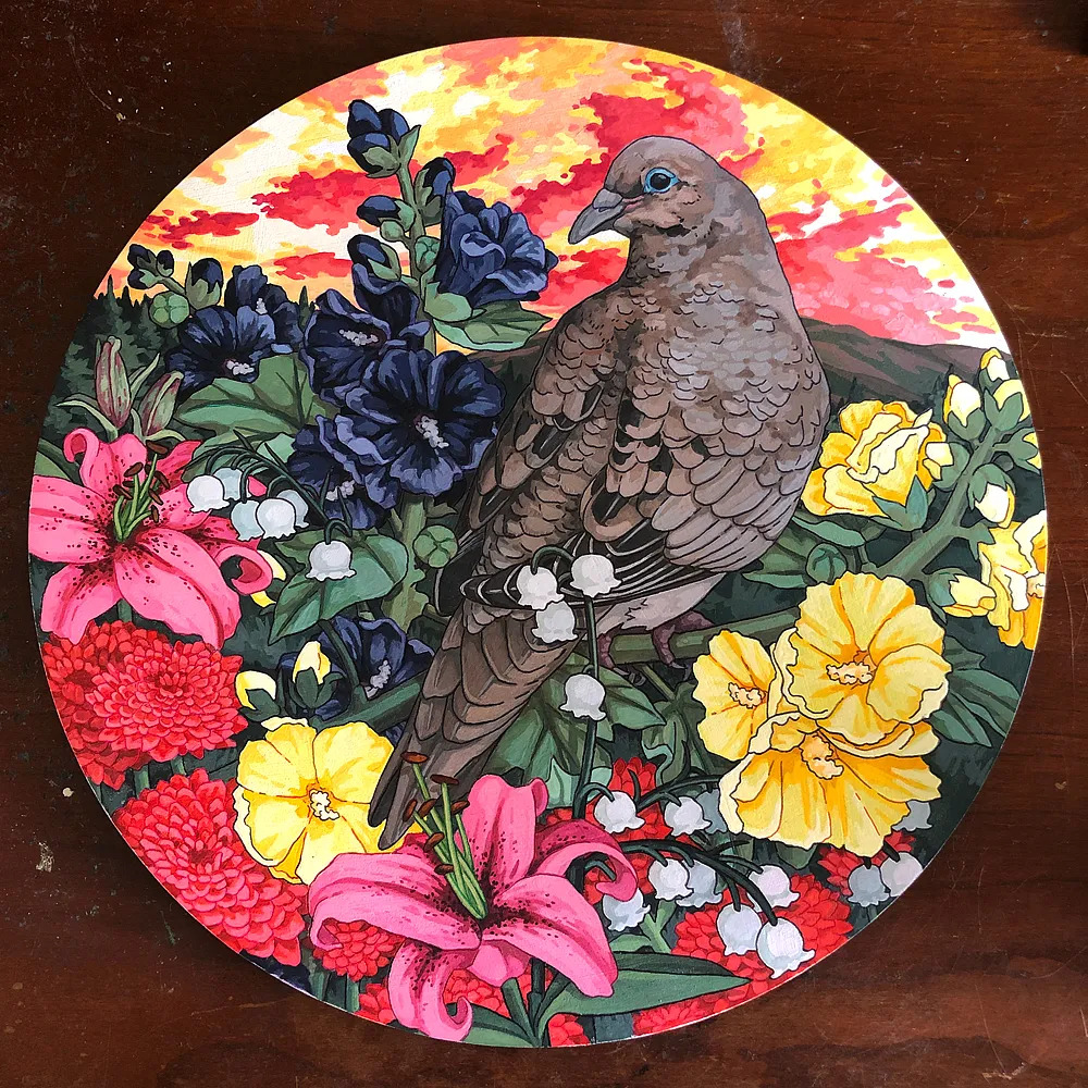 Painted mourning dove perched among colorful flowers with a vivid red and orange sky background