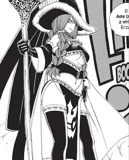 Manga panel of a female character in witch attire holding a staff with a large hat and cape