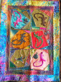 Handmade quilt with six panels showing colorful lizards in various poses, decorated with beads and embroidery