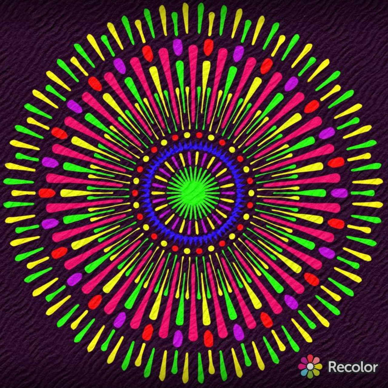 Circular mandala with colorful radiating spokes in neon pink, green, yellow and orange against dark purple