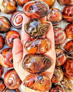 Polished agate slice with concentric banded rings resembling eyes