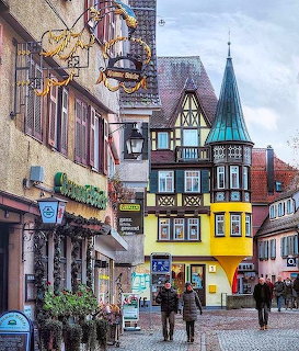 Colorful half-timbered buildings along a cobblestone street in a Bavarian old town