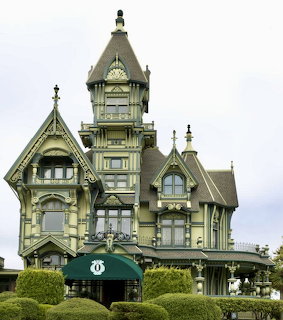 Victorian Carson Mansion with ornate woodwork, tower, and green hedges in Eureka, California
