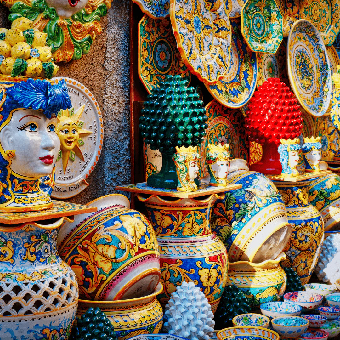 Colorful Italian majolica pottery with intricate hand-painted designs in blue, yellow, and green