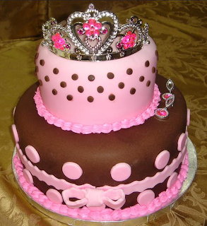 Two-tier pink and brown cake with polka dots and princess tiara