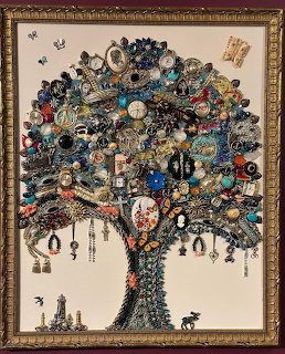 Framed artwork of a tree made from hundreds of pieces of vintage jewelry, brooches, and trinkets