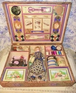Vintage child's milliner's kit box with porcelain doll, miniature sewing machine, ribbons, and sewing accessories