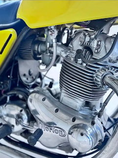Close-up of a Norton Commando motorcycle engine with chrome and finned metal details