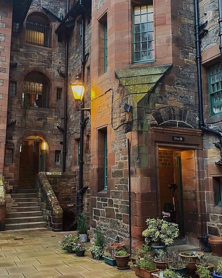 Stone courtyard with historic buildings and warm lighting in Dean Village, Edinburgh