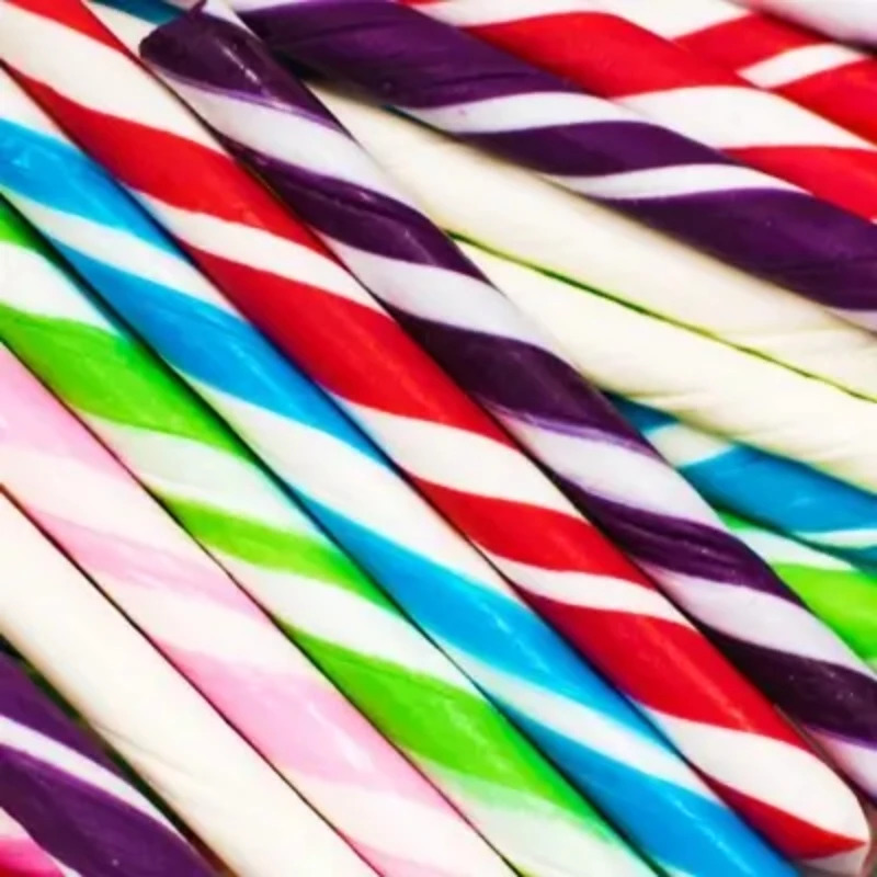 Diagonal arrangement of colorful striped candy sticks in red, purple, blue, green, and white