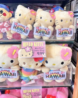 Shelves of Hello Kitty mini plush toys with I Love Hawaii signs and a price tag