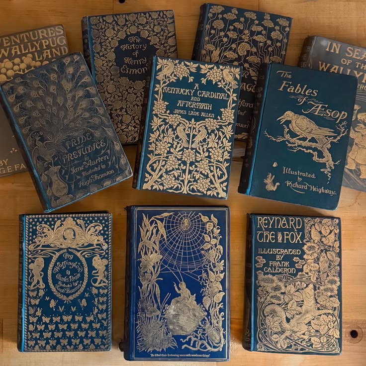 Collection of antique books with ornate blue and gold decorative covers arranged together