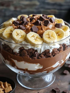 Layered chocolate dessert with banana slices in a glass serving bowl