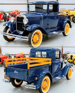 Blue 1930 Ford Model A truck with yellow wheels displayed in showroom, front and rear views