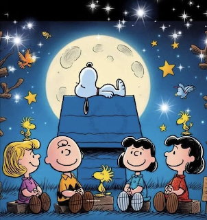 Snoopy lying on doghouse under full moon with Charlie Brown and friends sitting below among stars and falling leaves