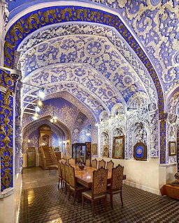 Ornate vaulted ceiling with intricate blue and white floral patterns in historic interior hall