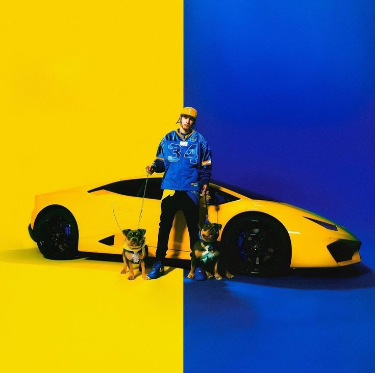 Man with two dogs standing in front of a yellow sports car on a blue and yellow background