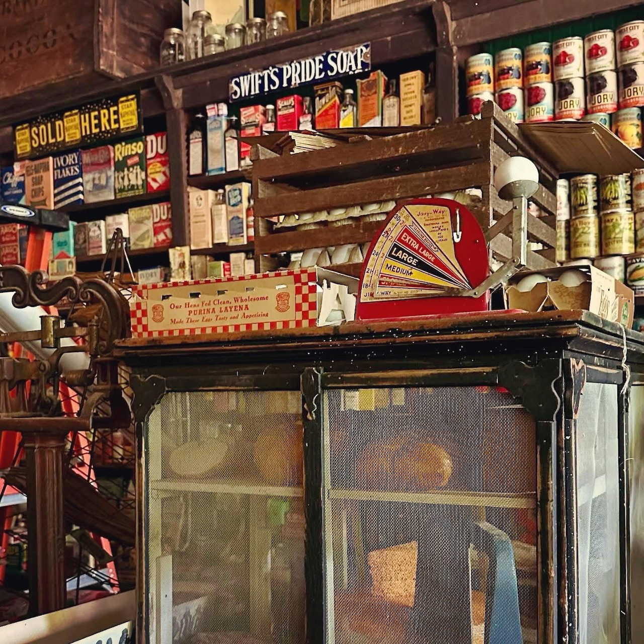 Vintage general store interior with shelves of old products, scale, and nostalgic signs