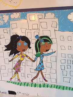 Children's drawing of two girls holding hands in front of white city buildings with sun and clouds