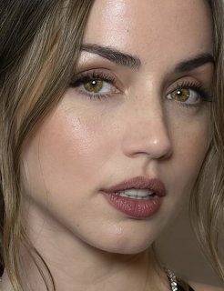 Close-up portrait of a young woman with green eyes and light brown hair