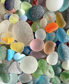 Collection of colorful smooth sea glass pieces in various sizes and pastel colors