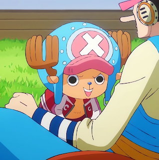Cartoon reindeer character Chopper with pink hat and blue cross symbol smiling at camera