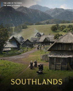 Traditional village with thatched huts in mountain valley with dramatic peaks