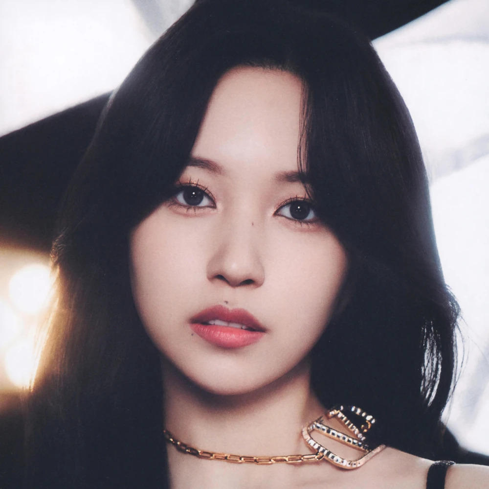 Close-up portrait of a young woman with long dark hair and a black top