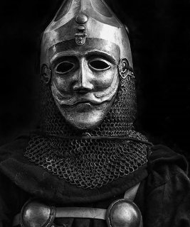 Black and white portrait of a medieval knight in helmet and chainmail