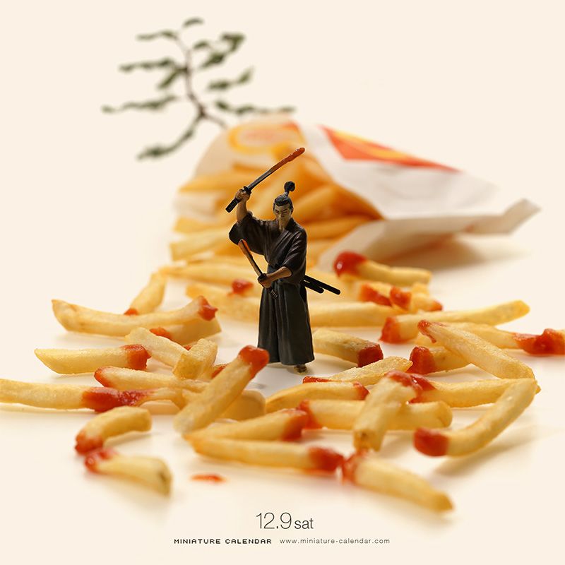 Miniature samurai figure standing among french fries and ketchup on a white background