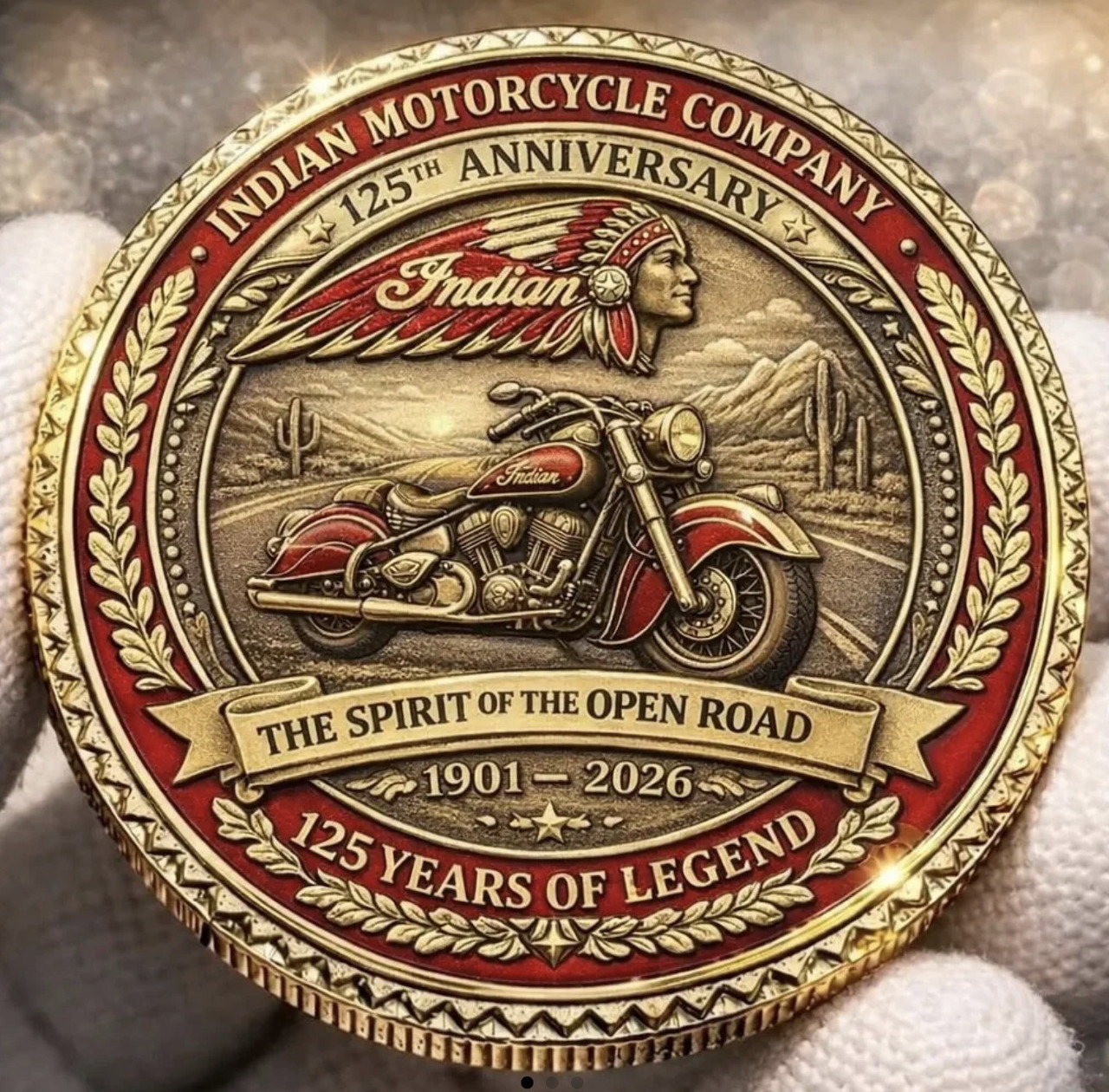 Gold Indian Motorcycle Company 125th anniversary commemorative coin with motorcycle and Native American chief design
