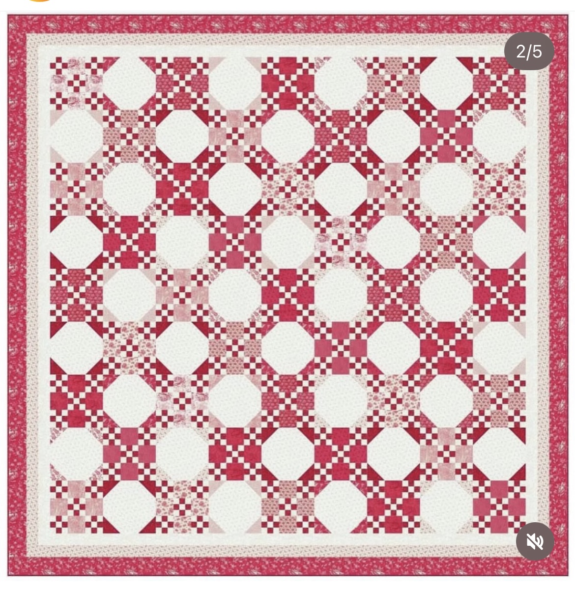 Red and white patchwork quilt with repeating geometric blocks and border