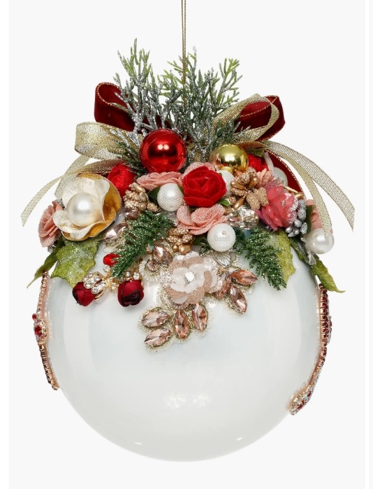 White Christmas bauble decorated with red roses, evergreen, ribbons, pearls, beads, and gold jewelry.